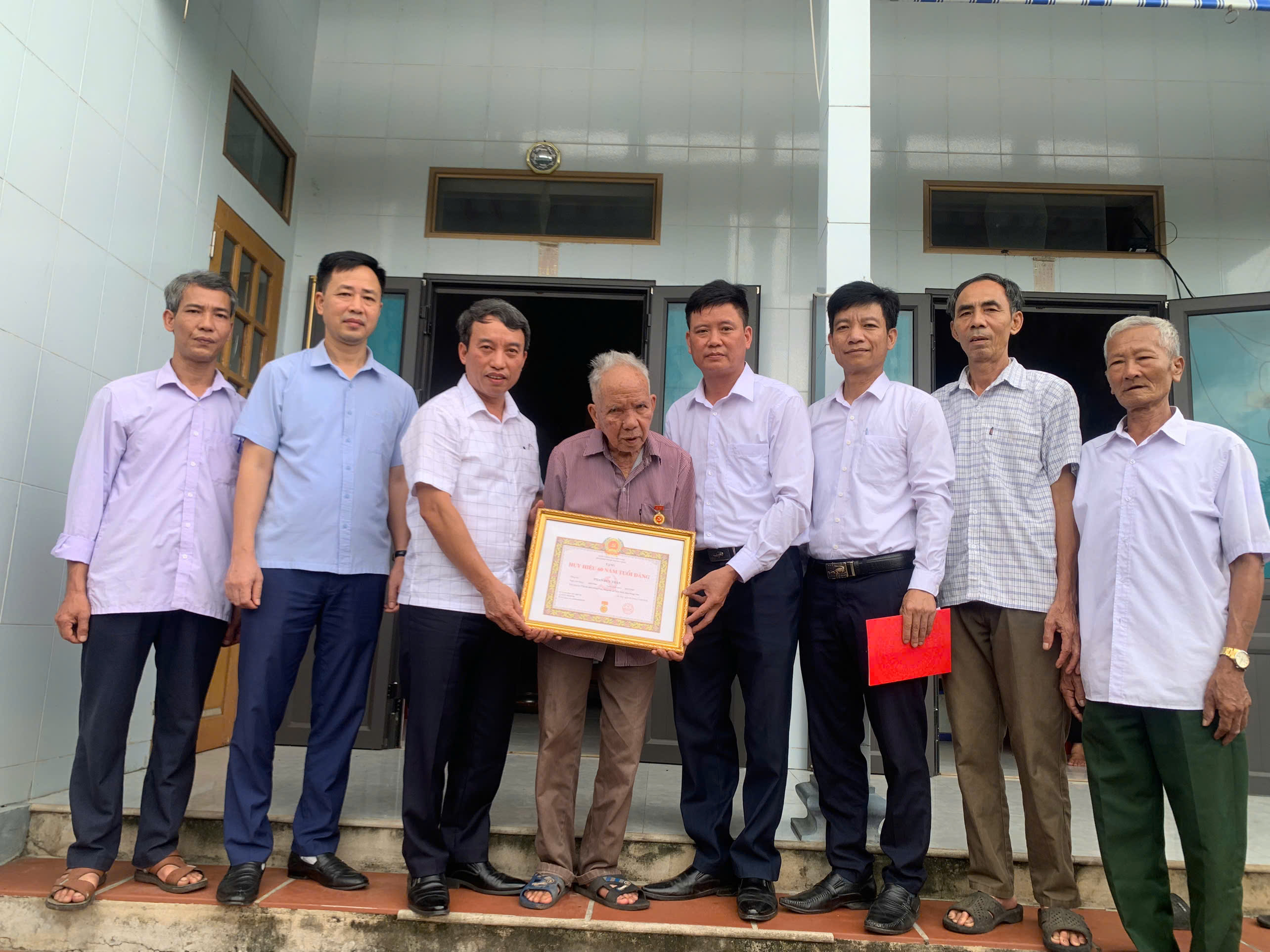 Đồng chí Bùi Xuân Phóng Bí thư Đảng ủy Chủ tịch HĐND xã trao Huy hiệu Đảng cho các đảng viên cao tuổi Đảng